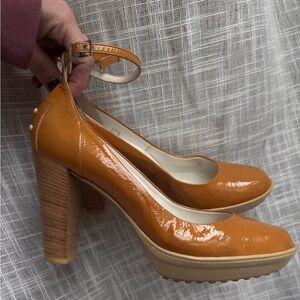 Tods Mustard heels with heel embellishments and ankle strap.